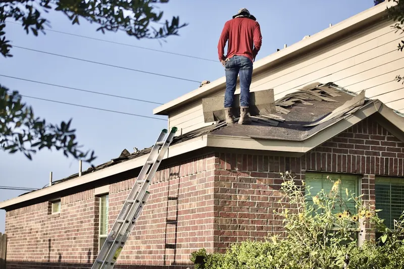 Professional roofer working on a residential roof in Munger